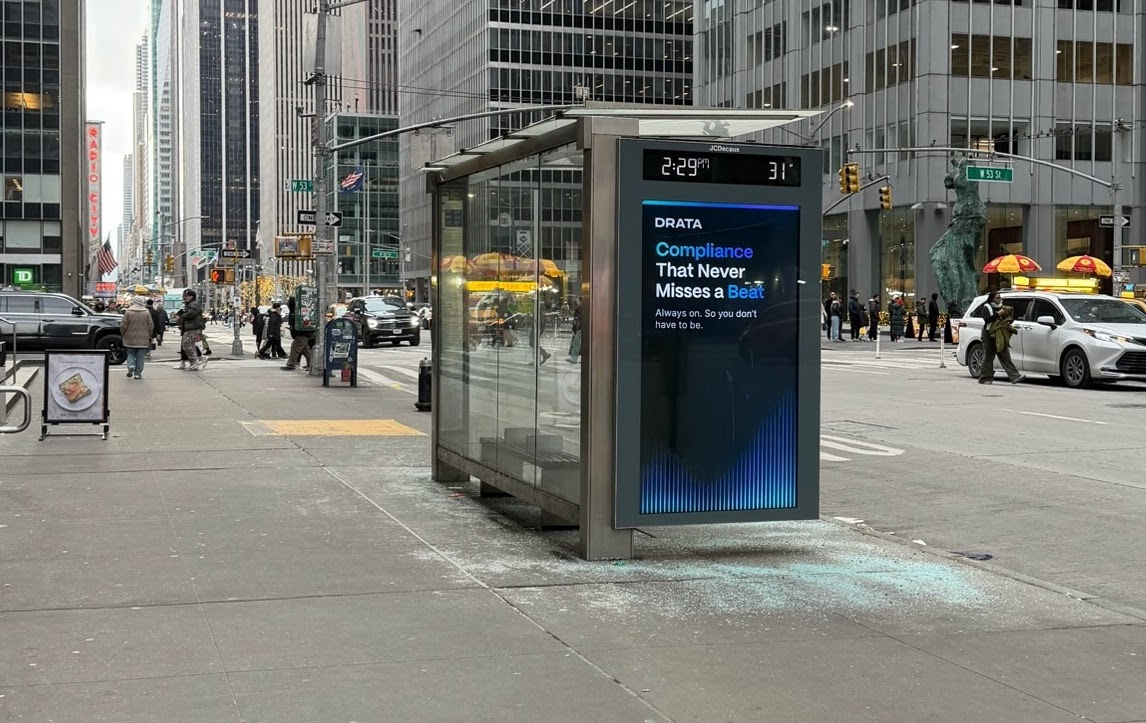 Drata compliance bus shelter on 6th Ave near Radio City Music Hall, NYC