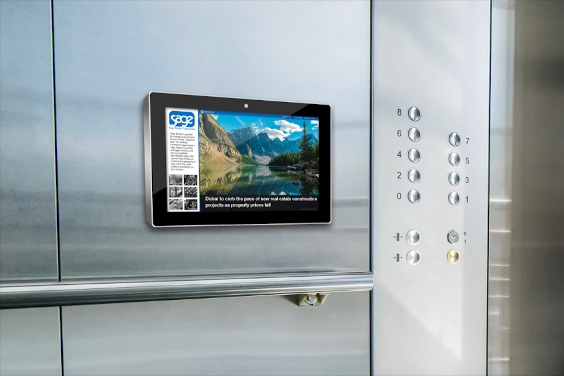 Captive digital screen inside an office building elevator running real-estate brand content — ABM placement targeting workers riding to their floor