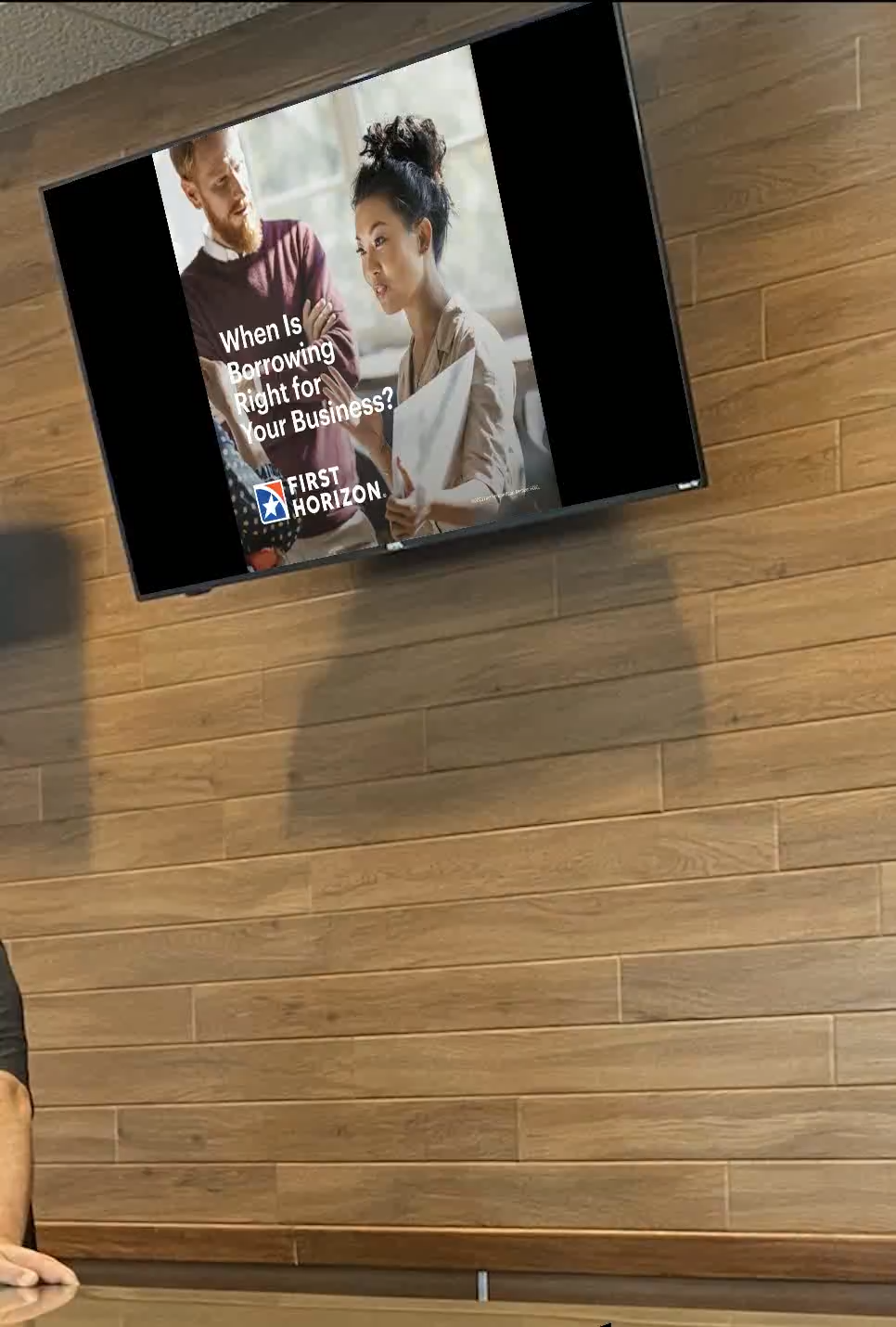 First Horizon business-banking creative on an office lobby screen