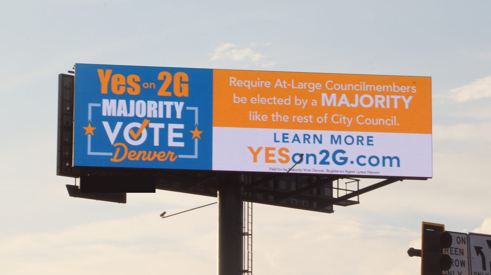 A digital billboard running a Denver ballot-measure ad reading Yes on 2G, Majority Vote Denver, against an evening sky.